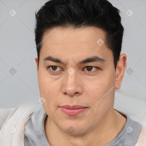 Joyful asian adult male with short  brown hair and brown eyes