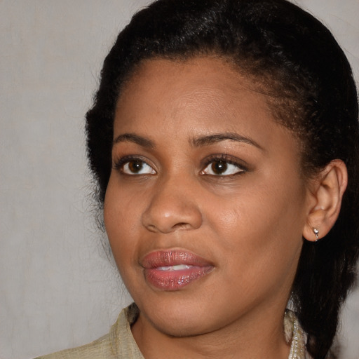 Joyful black young-adult female with medium  brown hair and brown eyes