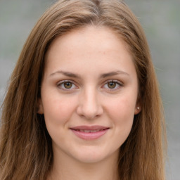 Joyful white young-adult female with long  brown hair and green eyes