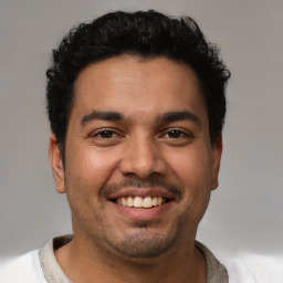 Joyful white young-adult male with short  black hair and brown eyes