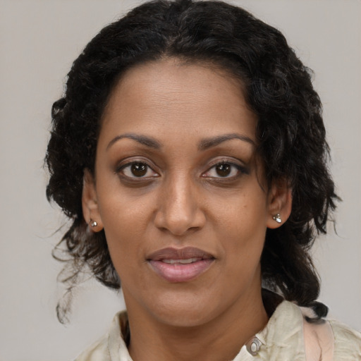 Joyful black adult female with medium  brown hair and brown eyes