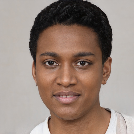 Joyful black young-adult male with short  black hair and brown eyes