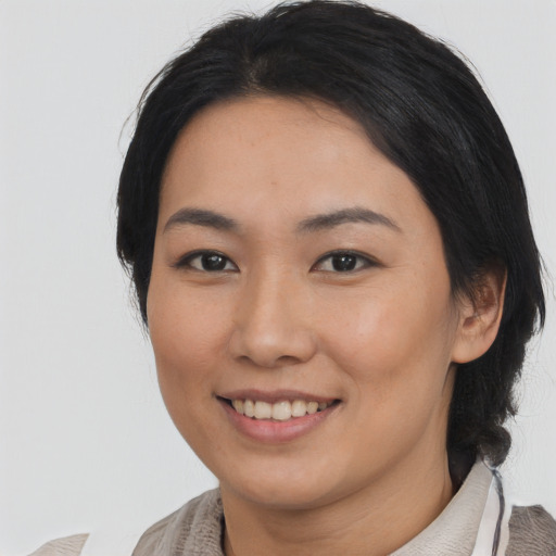 Joyful asian young-adult female with medium  black hair and brown eyes