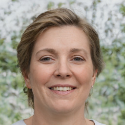 Joyful white adult female with medium  brown hair and brown eyes