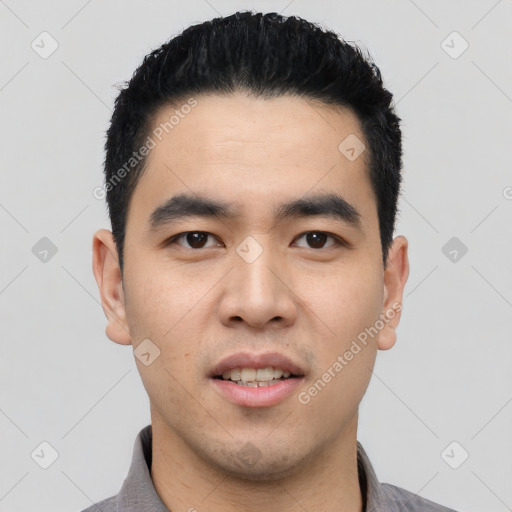 Joyful asian young-adult male with short  black hair and brown eyes