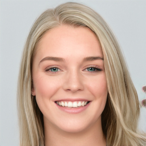 Joyful white young-adult female with long  brown hair and blue eyes