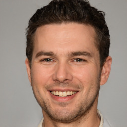 Joyful white adult male with short  brown hair and brown eyes