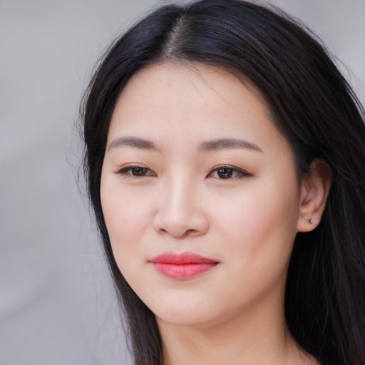 Joyful white young-adult female with long  black hair and brown eyes