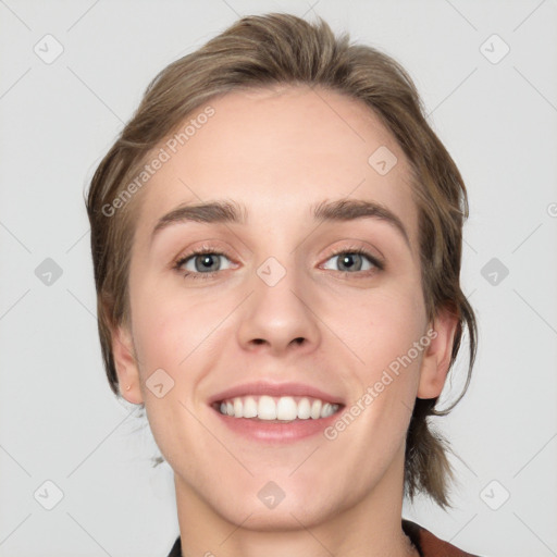 Joyful white young-adult female with medium  brown hair and grey eyes