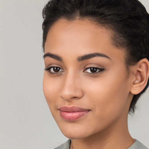 Joyful latino young-adult female with long  brown hair and brown eyes