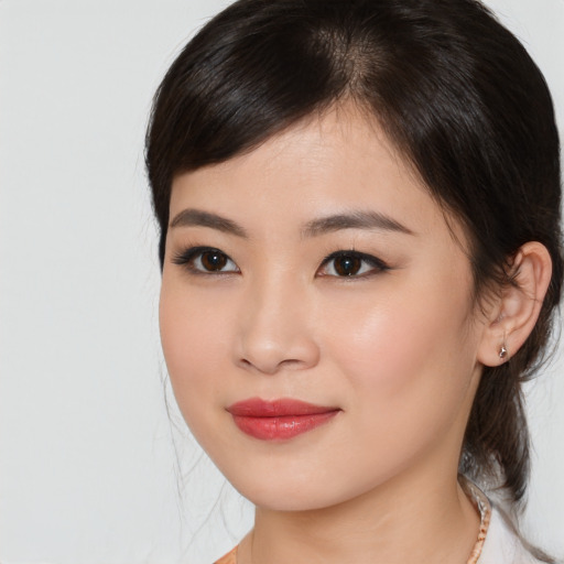 Joyful asian young-adult female with medium  brown hair and brown eyes