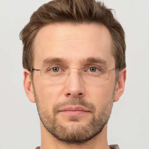 Joyful white adult male with short  brown hair and grey eyes