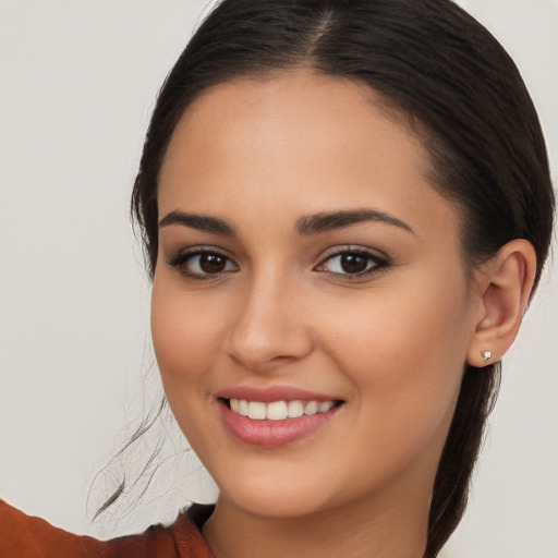 Joyful white young-adult female with long  brown hair and brown eyes