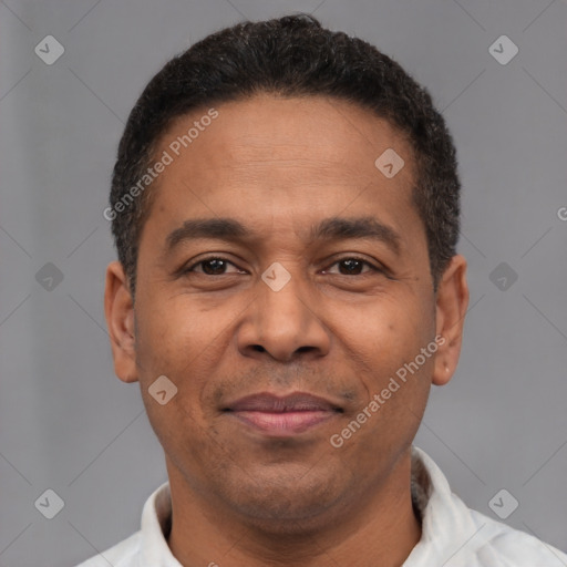 Joyful latino adult male with short  brown hair and brown eyes