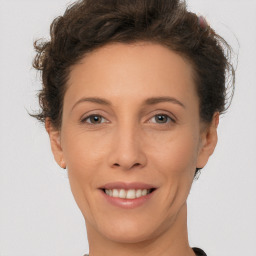 Joyful white adult female with short  brown hair and brown eyes