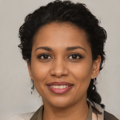 Joyful black young-adult female with medium  brown hair and brown eyes