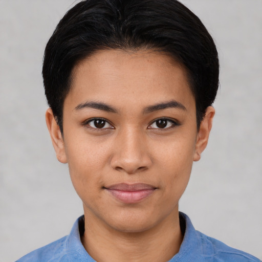 Joyful latino young-adult female with short  black hair and brown eyes