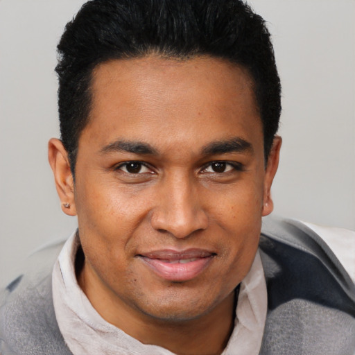 Joyful black young-adult male with short  brown hair and brown eyes