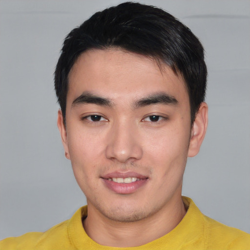 Joyful asian young-adult male with short  black hair and brown eyes