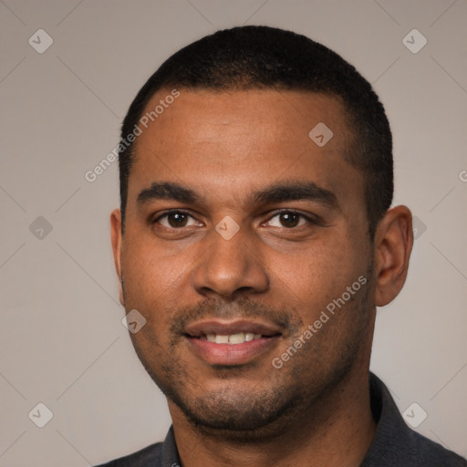 Joyful black young-adult male with short  black hair and brown eyes