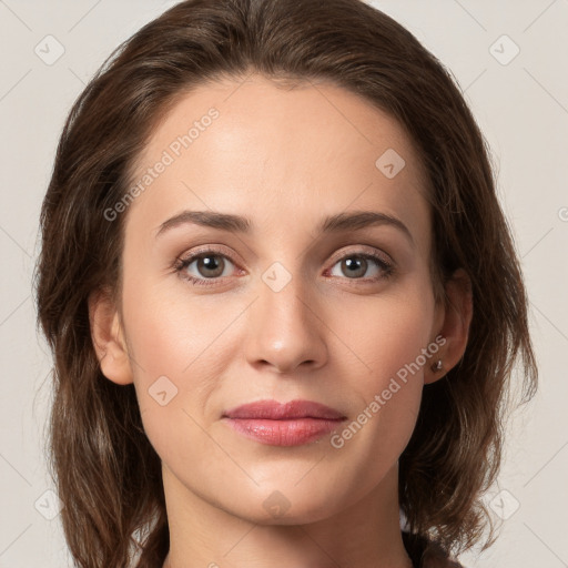 Joyful white young-adult female with long  brown hair and green eyes