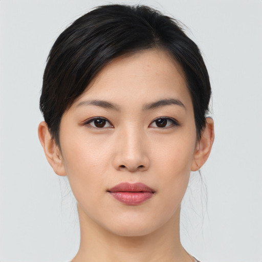Joyful asian young-adult female with medium  brown hair and brown eyes