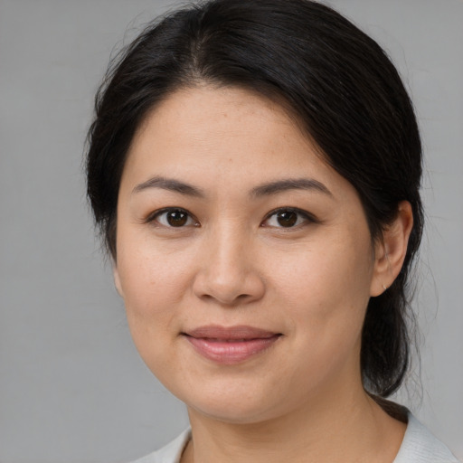 Joyful white young-adult female with medium  brown hair and brown eyes