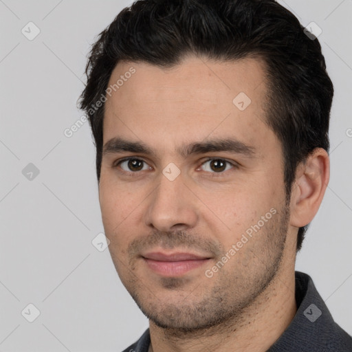 Joyful white young-adult male with short  black hair and brown eyes