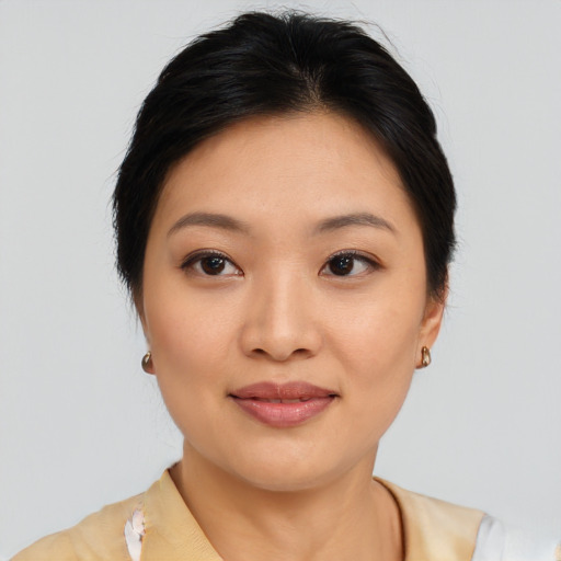 Joyful asian young-adult female with medium  brown hair and brown eyes