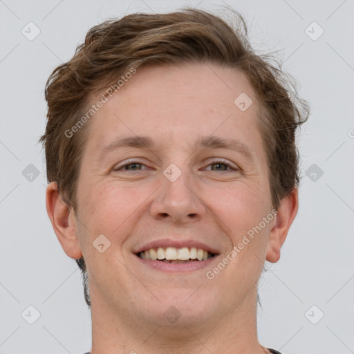 Joyful white adult male with short  brown hair and grey eyes