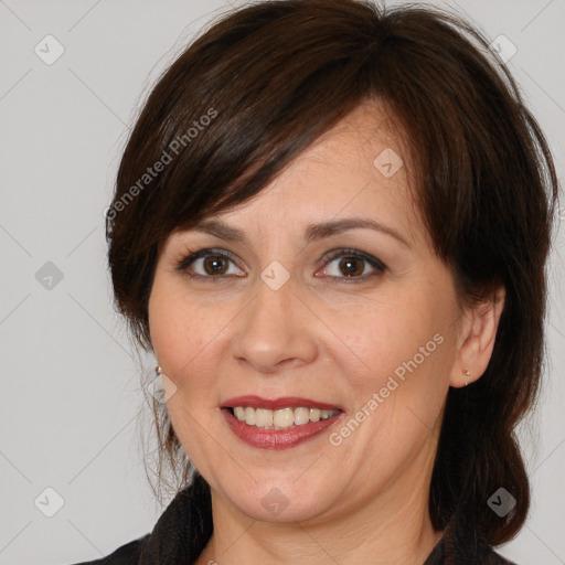 Joyful white adult female with medium  brown hair and brown eyes