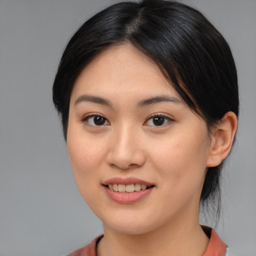 Joyful asian young-adult female with medium  brown hair and brown eyes