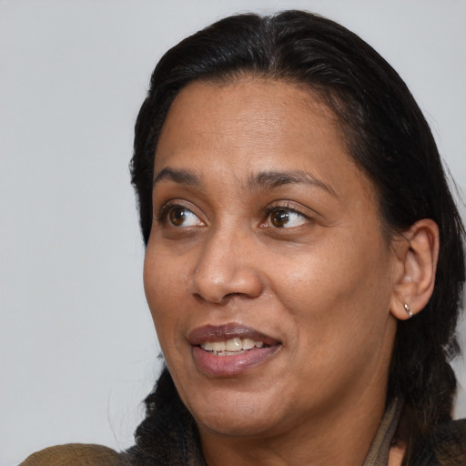 Joyful black adult female with medium  black hair and brown eyes