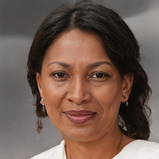 Joyful black adult female with medium  brown hair and brown eyes