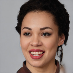 Joyful black young-adult female with medium  brown hair and brown eyes