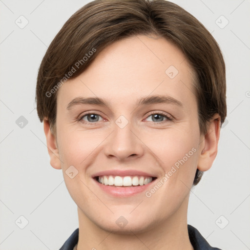 Joyful white young-adult female with short  brown hair and grey eyes