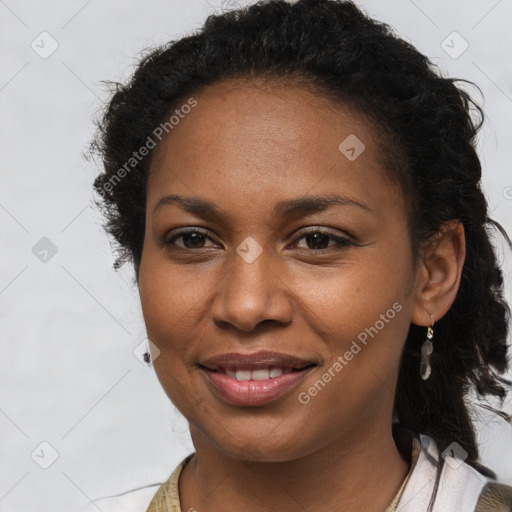 Joyful black young-adult female with long  brown hair and brown eyes