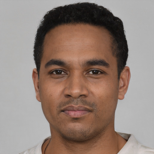 Neutral latino young-adult male with short  black hair and brown eyes