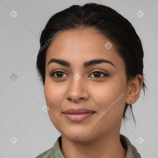 Joyful latino young-adult female with long  brown hair and brown eyes