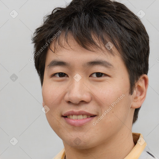 Joyful asian young-adult male with short  brown hair and brown eyes