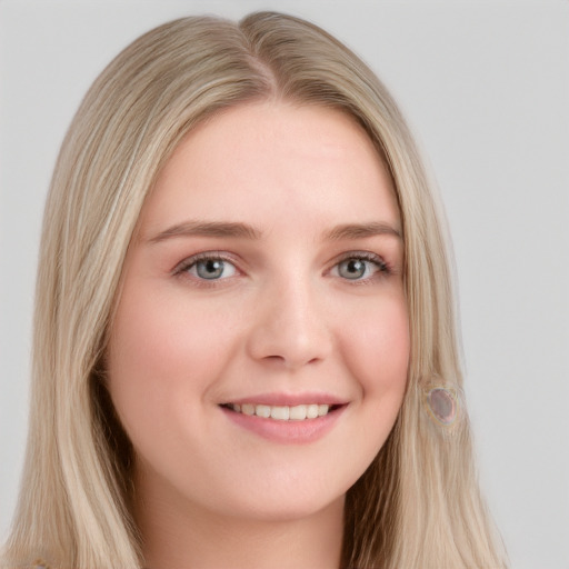 Joyful white young-adult female with long  blond hair and blue eyes