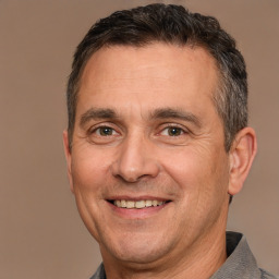 Joyful white adult male with short  brown hair and brown eyes