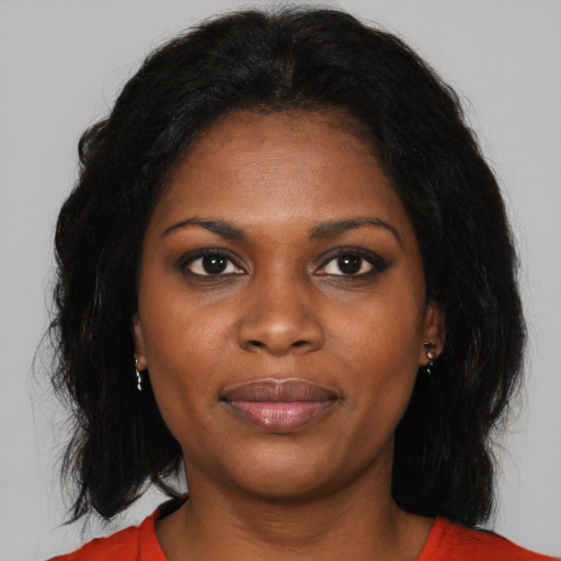 Joyful black young-adult female with medium  black hair and brown eyes