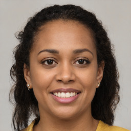 Joyful latino young-adult female with long  brown hair and brown eyes