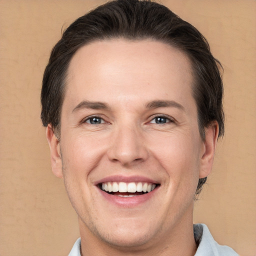 Joyful white adult male with short  brown hair and brown eyes