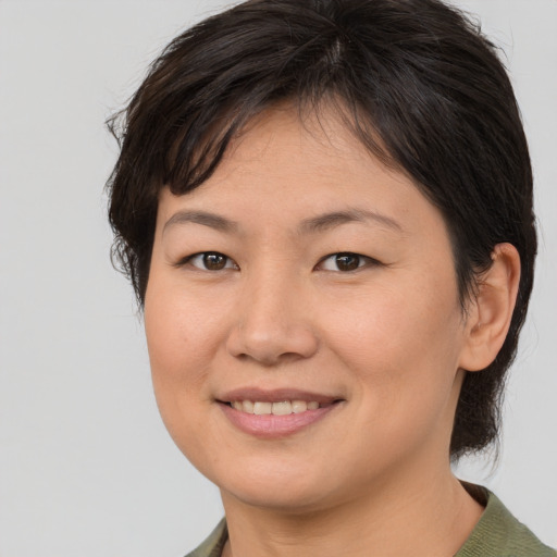 Joyful asian young-adult female with medium  brown hair and brown eyes