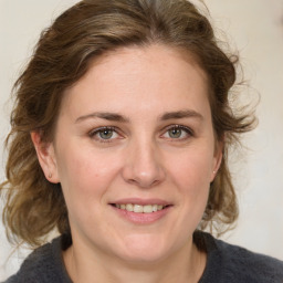 Joyful white young-adult female with medium  brown hair and blue eyes