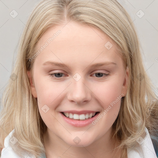 Joyful white young-adult female with long  brown hair and blue eyes