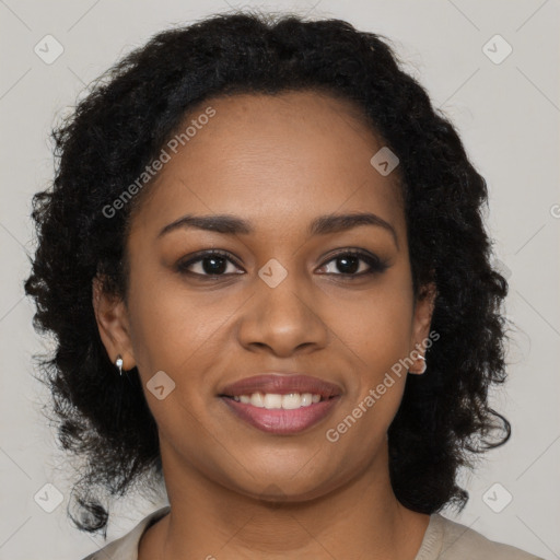 Joyful black young-adult female with long  brown hair and brown eyes