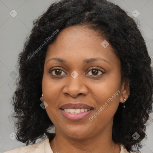 Joyful black young-adult female with long  brown hair and brown eyes